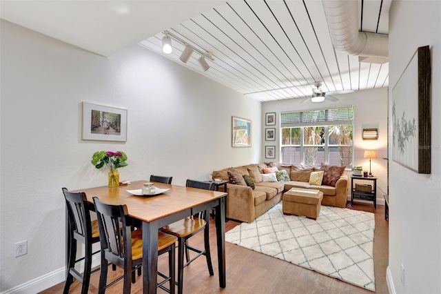 dining area featuring a ceiling fan, wood finished floors, and baseboards
