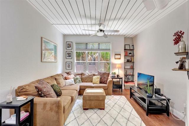 living area with ceiling fan and light wood-style flooring