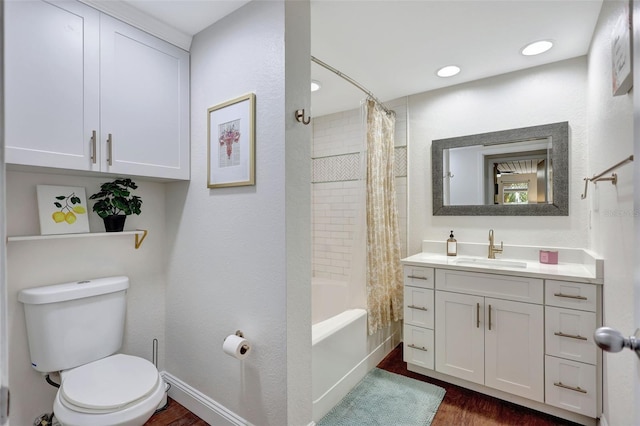 bathroom with shower / bath combo, wood finished floors, toilet, and vanity