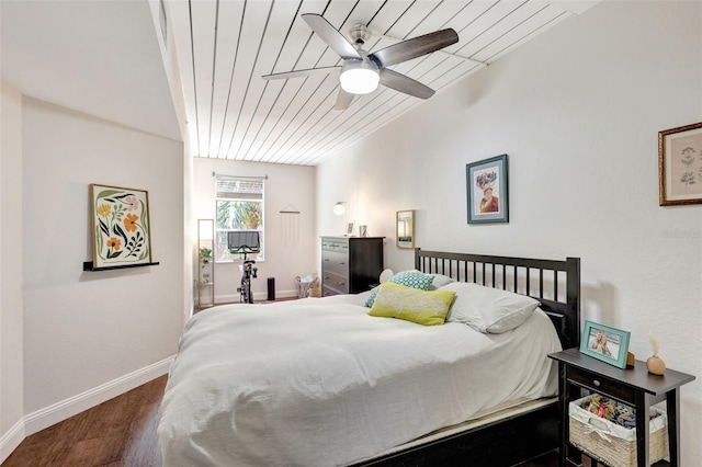 bedroom with wood finished floors, ceiling fan, baseboards, and wooden ceiling