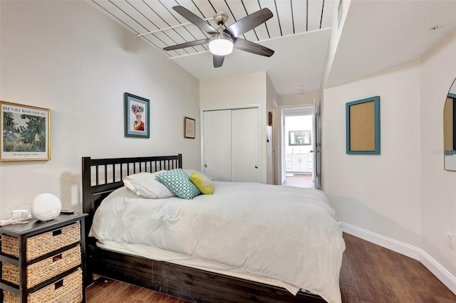 bedroom featuring a closet, a ceiling fan, wood finished floors, and baseboards