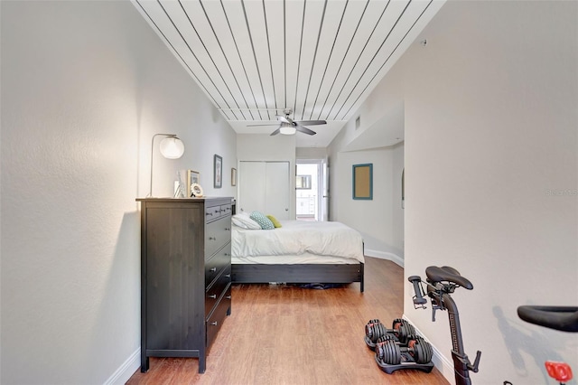 bedroom featuring ceiling fan, light wood-type flooring, and baseboards