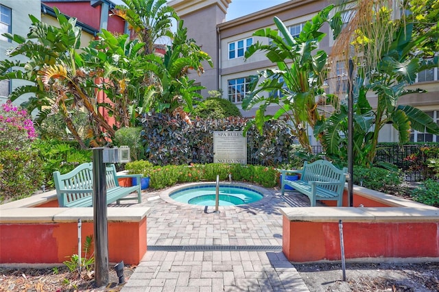 view of swimming pool with a hot tub