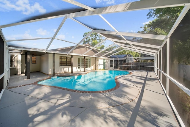 view of swimming pool featuring a patio, french doors, fence, and glass enclosure
