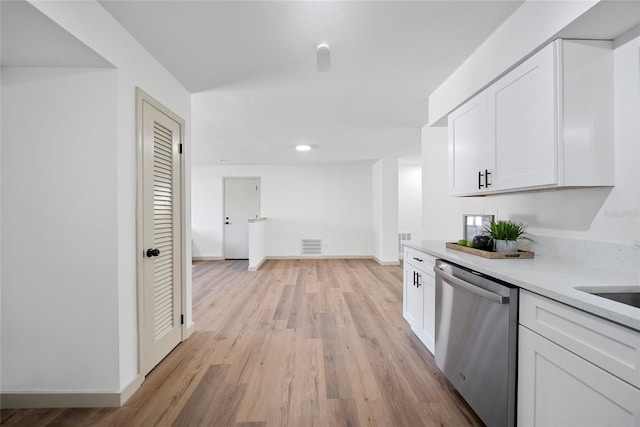 kitchen with stainless steel dishwasher, light countertops, white cabinets, light wood finished floors, and recessed lighting