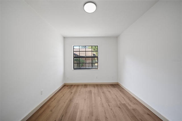 unfurnished room with light wood-style flooring and baseboards