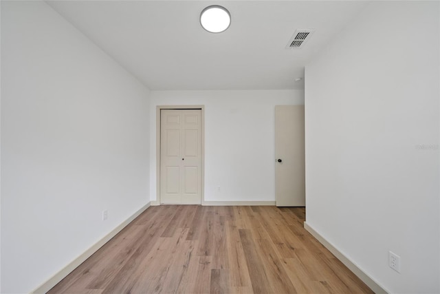 unfurnished room with light wood finished floors and baseboards