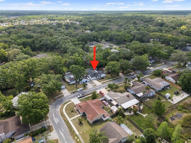 aerial view of residential area featuring a forest