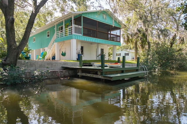 7417 Seagull Way, Tampa, FL 33635 - back of house with a sunroom, a water view, and stairs