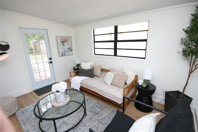 living room featuring baseboards, vaulted ceiling, and wood finished floors