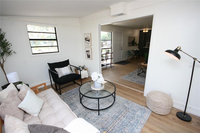 living room with baseboards and wood finished floors