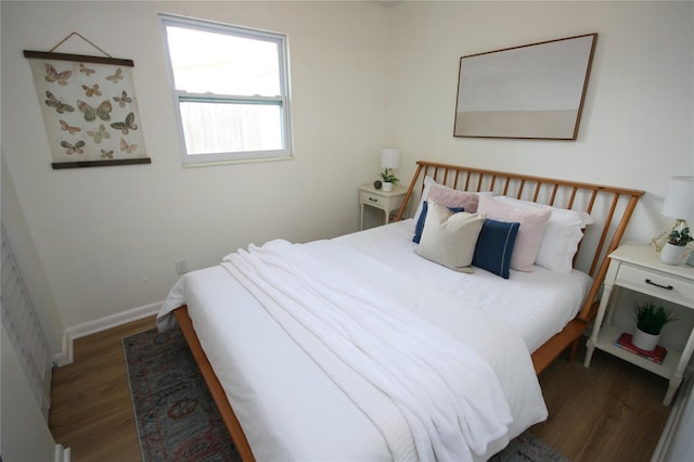 bedroom featuring baseboards and wood finished floors
