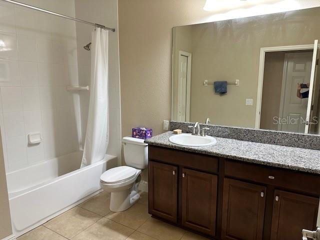 full bath featuring vanity, toilet, shower / bath combo with shower curtain, and tile patterned floors