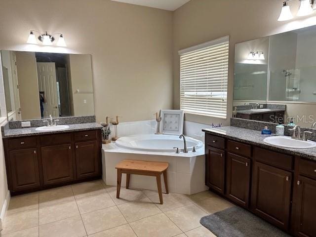bathroom with a bath, tile patterned flooring, and a sink