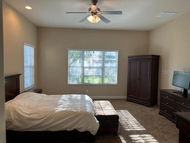 bedroom with visible vents, recessed lighting, ceiling fan, light carpet, and baseboards