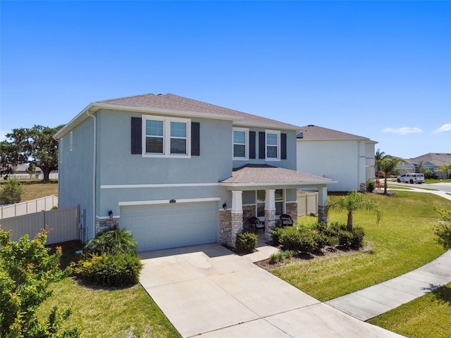 traditional home with a front yard, a garage, fence, concrete driveway, and stone siding