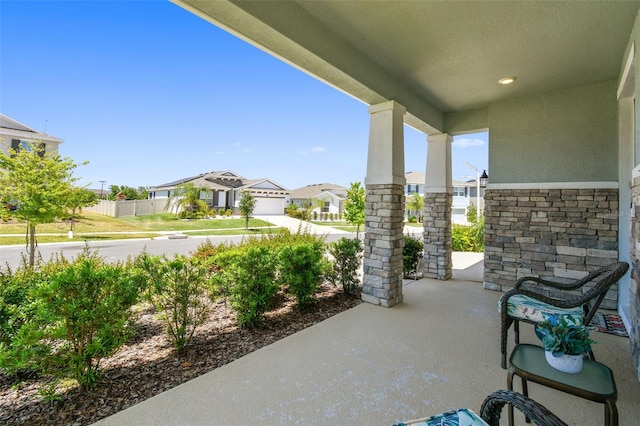 view of patio featuring a porch and a residential view
