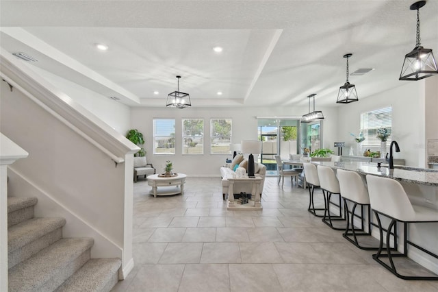 living room featuring recessed lighting, visible vents, stairs, and a wealth of natural light