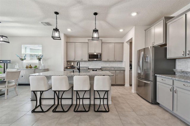 kitchen with visible vents, gray cabinets, and appliances with stainless steel finishes