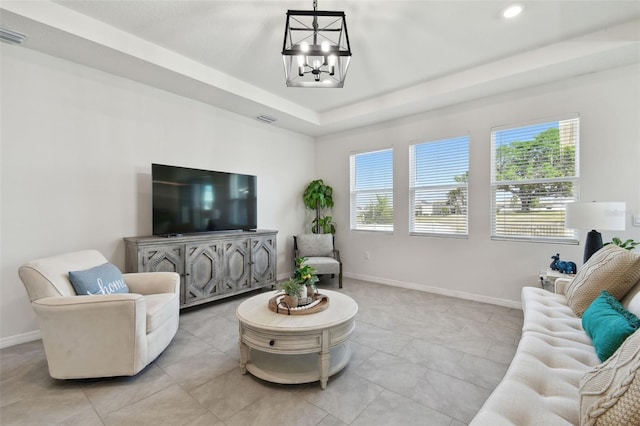 living area featuring a healthy amount of sunlight, baseboards, recessed lighting, and a chandelier