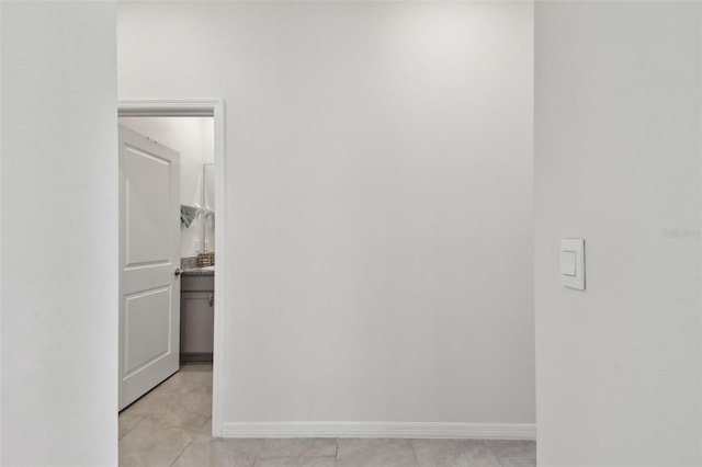 interior space with light tile patterned floors and baseboards