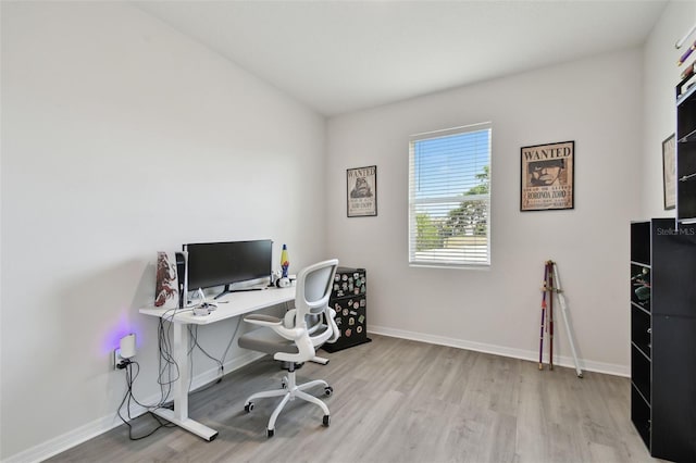 office area with baseboards and wood finished floors