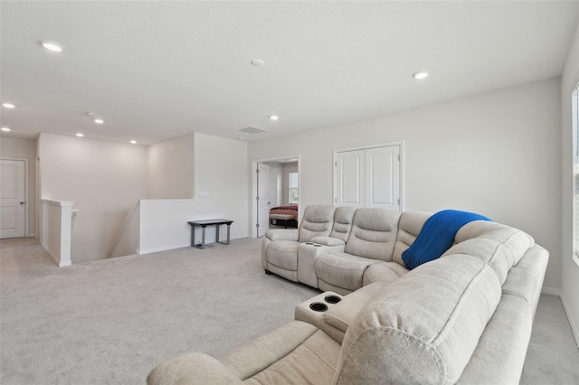 living area featuring recessed lighting, baseboards, and light colored carpet