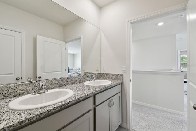 bathroom with a sink and double vanity