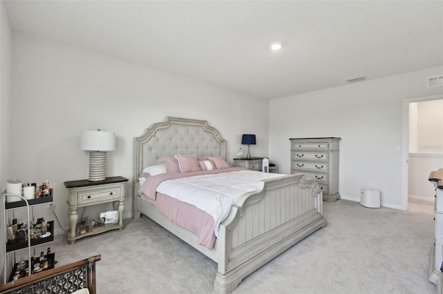 bedroom featuring baseboards, visible vents, and light colored carpet