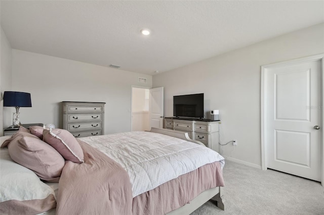 bedroom with baseboards, light colored carpet, and visible vents