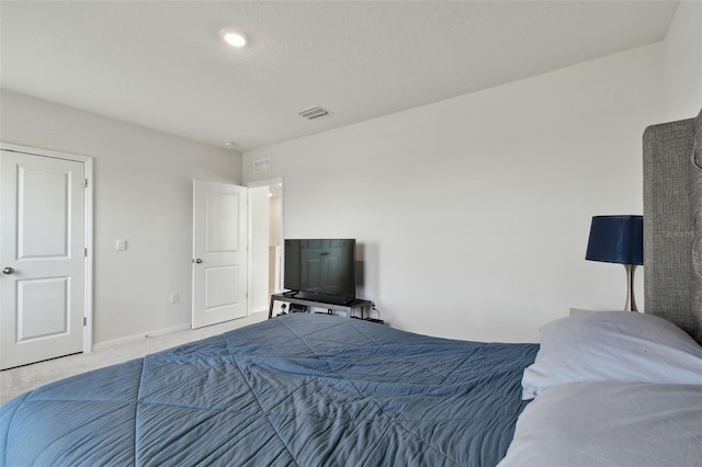 carpeted bedroom featuring baseboards and visible vents