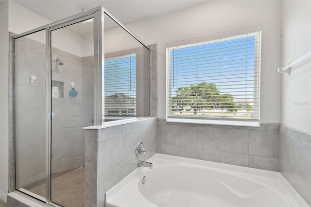 full bathroom with a garden tub and a shower stall