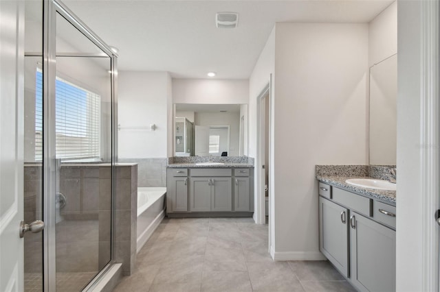 bathroom with a garden tub, two vanities, tile patterned flooring, and a stall shower
