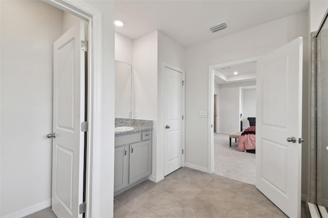 bathroom with visible vents, walk in shower, vanity, baseboards, and recessed lighting