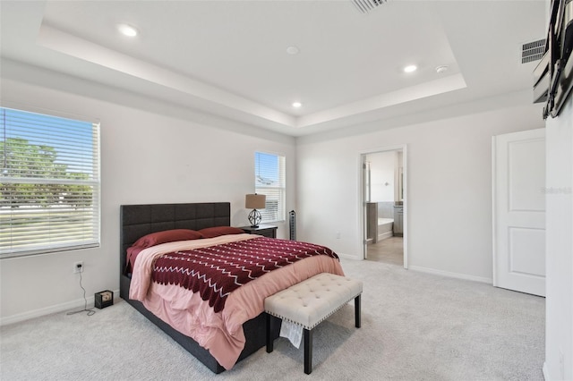 bedroom featuring recessed lighting, baseboards, light carpet, and a raised ceiling