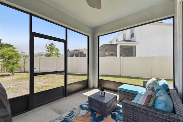 sunroom / solarium featuring a ceiling fan and an outdoor hangout area
