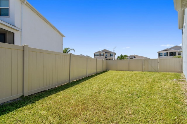 view of yard with a gate and a fenced backyard