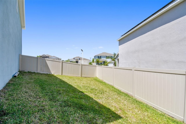 view of yard with a residential view and a fenced backyard