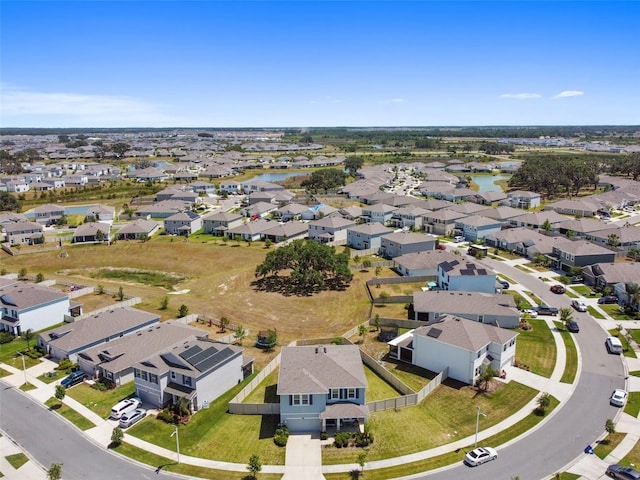 birds eye view of property with a water view and a residential view