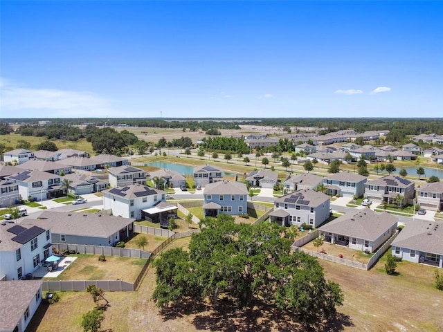 birds eye view of property with a residential view and a water view