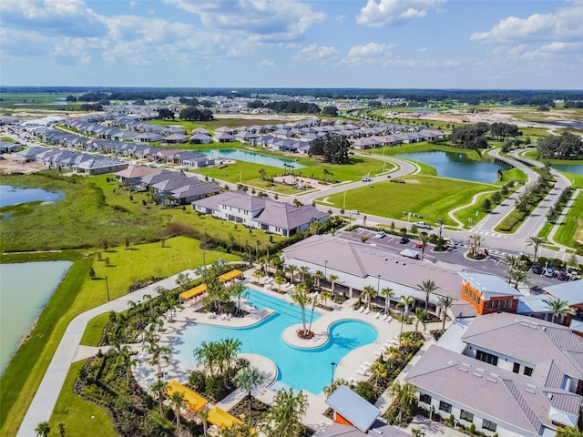 birds eye view of property featuring a water view and a residential view