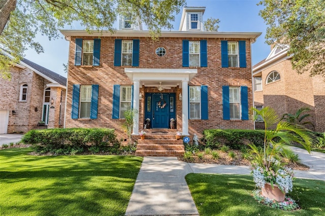 2704 Chambray Ln, Tampa, FL 33611 - colonial inspired home with a front lawn and brick siding