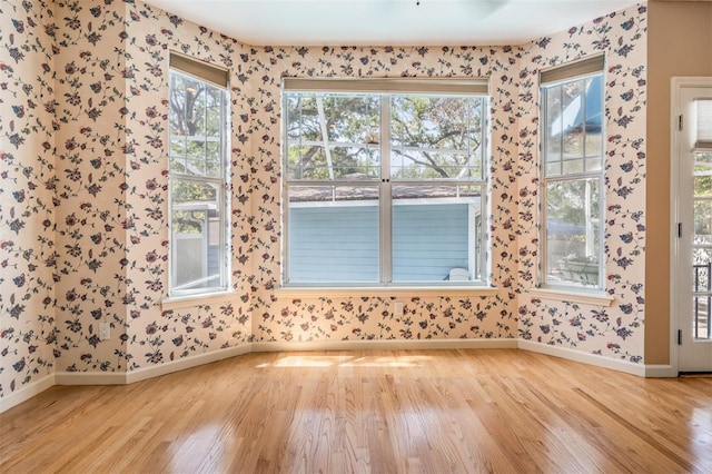 2704 Chambray Ln, Tampa, FL 33611 - unfurnished room featuring wood finished floors, wallpapered walls, and baseboards