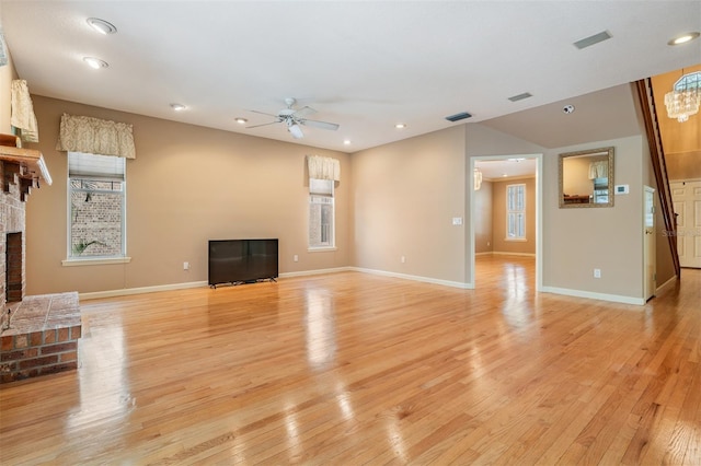 2704 Chambray Ln, Tampa, FL 33611 - unfurnished living room featuring a ceiling fan, light wood-type flooring, baseboards, a fireplace, and recessed lighting
