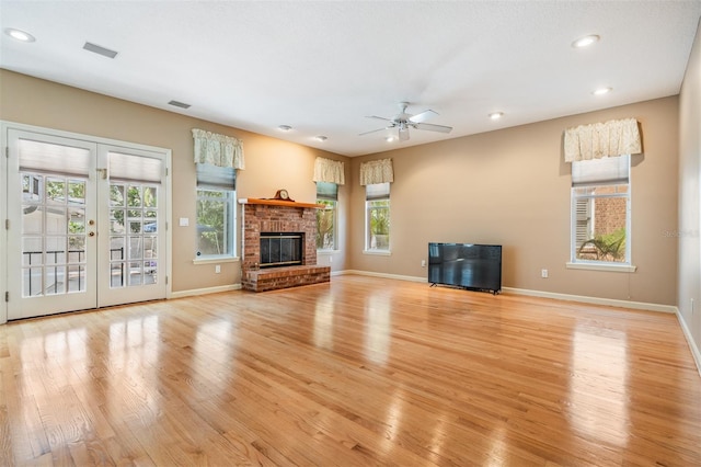 2704 Chambray Ln, Tampa, FL 33611 - unfurnished living room featuring light wood-style floors, a ceiling fan, recessed lighting, baseboards, and french doors