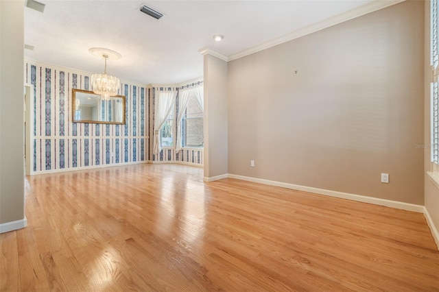 2704 Chambray Ln, Tampa, FL 33611 - unfurnished room featuring crown molding, a chandelier, baseboards, light wood-type flooring, and wallpapered walls