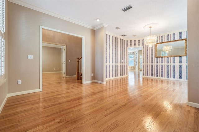 2704 Chambray Ln, Tampa, FL 33611 - unfurnished room featuring a chandelier, crown molding, light wood-style floors, and baseboards