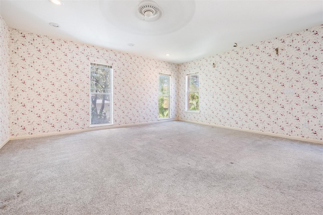 2704 Chambray Ln, Tampa, FL 33611 - spare room with wallpapered walls, carpet, and baseboards
