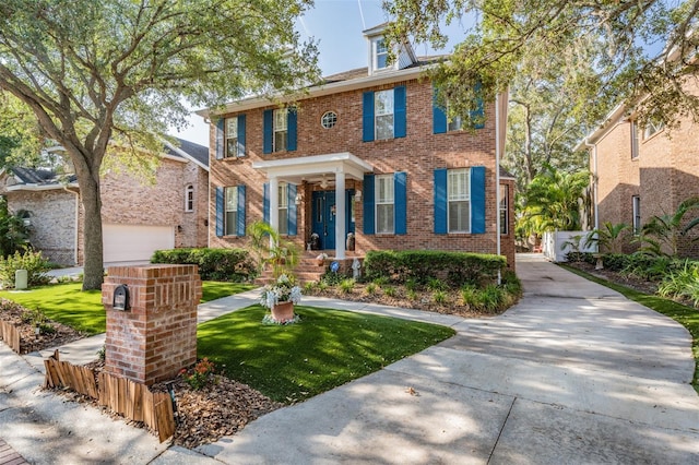 2704 Chambray Ln, Tampa, FL 33611 - georgian-style home featuring brick siding and a front yard