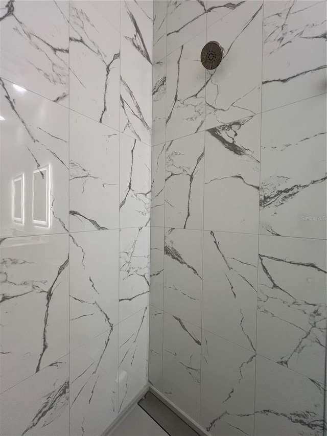 bathroom with a tile shower